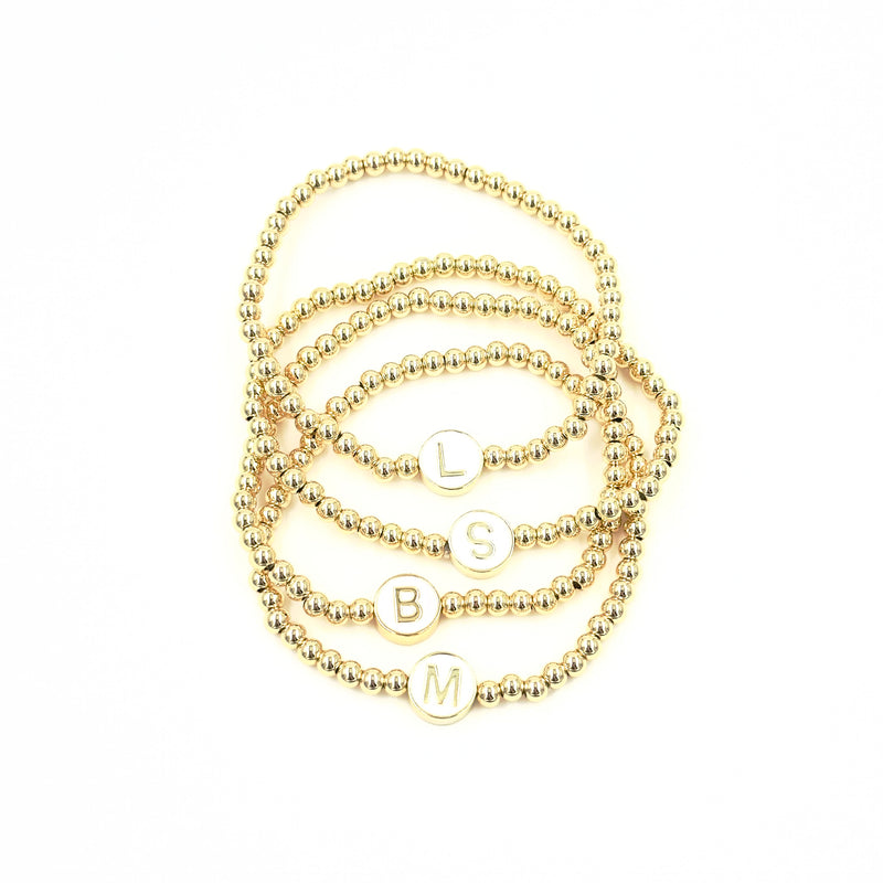 Ashley Gold Stainless Steel Gold Plated White Enamel Letter Bead Stretch Beaded Bracelet